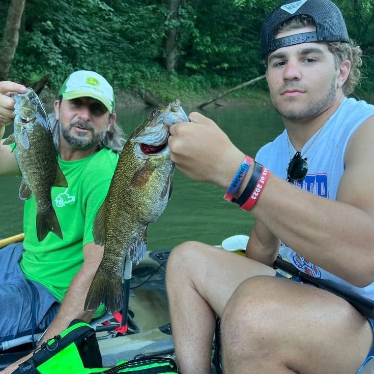 Justin and Andrew Rollyson holding smallmouth bass caught on the Elk River WV near Corton Lodge